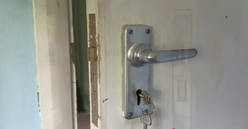 Door lever handle with a key in the lock