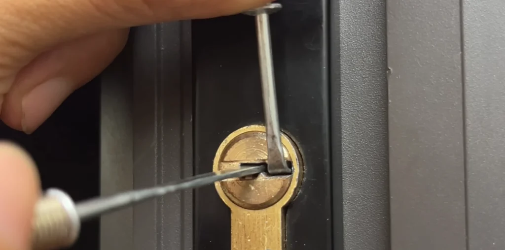 Close-up of a pick tool inside a brass lock cylinder
